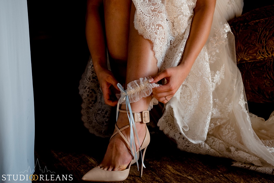 A bride puts on her garter before her wedding at the Berry Barn