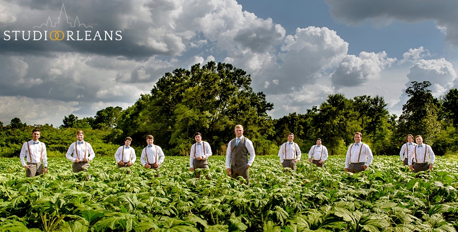 A groom and his groomsmen stand in a field before the wedding ceremony at Berry Barn